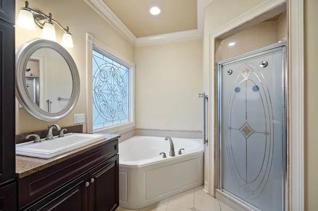 a bathroom with a bathtub sink mirror and vanity