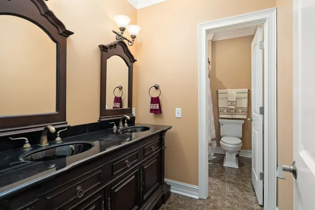 a bathroom with a double vanity sink and a mirror
