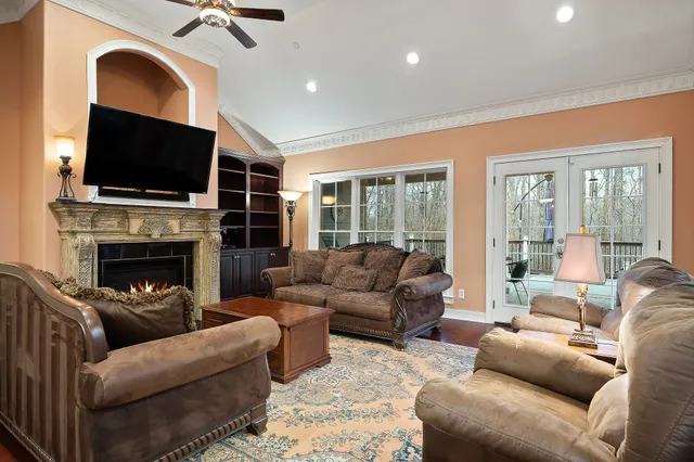 a living room with furniture a flat screen tv and a fireplace