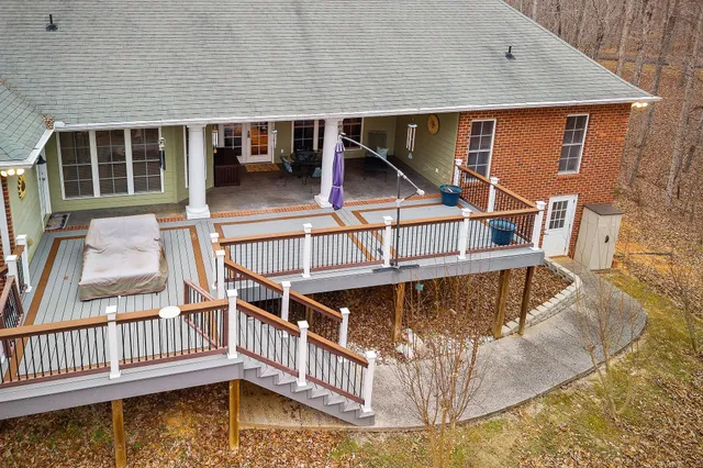 a view of a house with backyard and deck