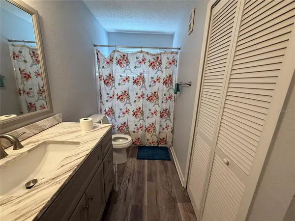 a bathroom with a sink a mirror and a shower