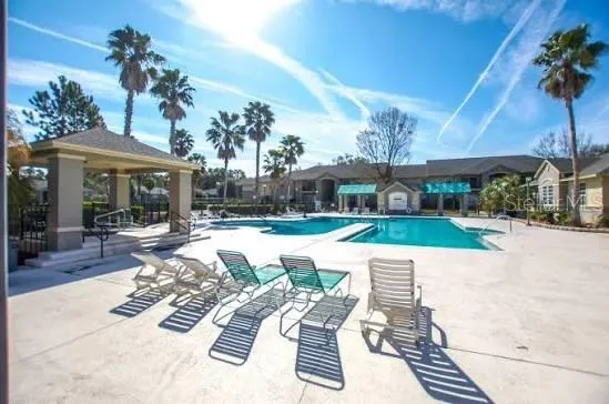 a view of a house with swimming pool and porch with furniture