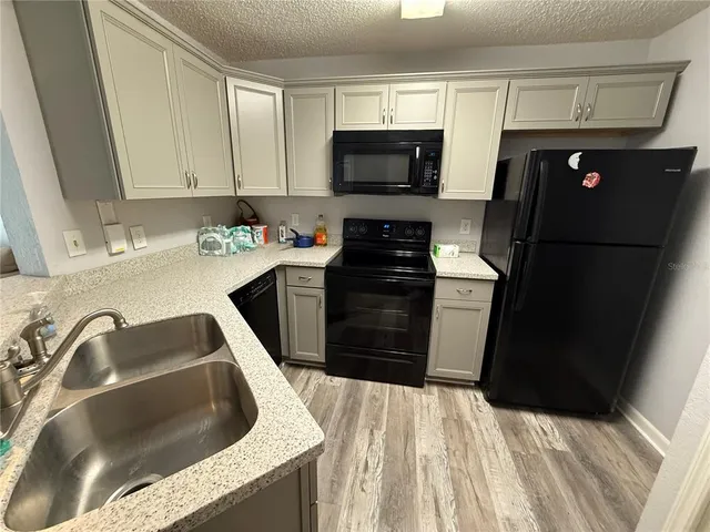 a kitchen with a sink dishwasher and stove