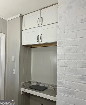 a large bed sitting in a bedroom next to a window