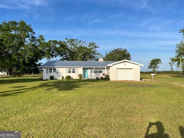 16877 Highway 129 Cobbtown, GA 30420 - Photo 3 of 45 a front view of a house with a yard