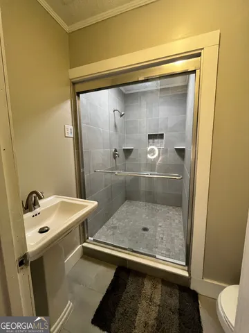 a living room with furniture a flat screen tv and a large window