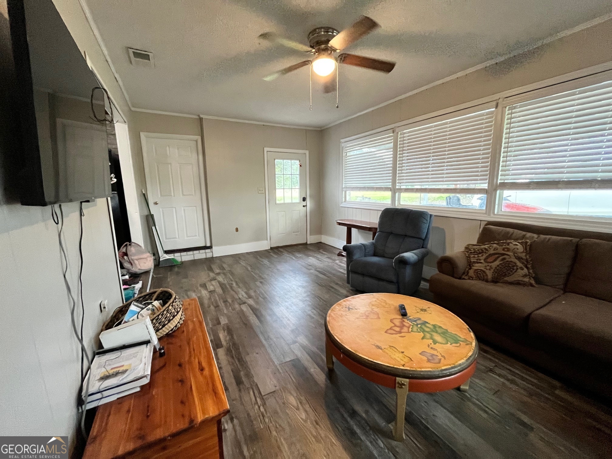 16877 Highway 129 Cobbtown, GA 30420 - Photo 34 of 45 a living room with furniture a flat screen tv and a large window