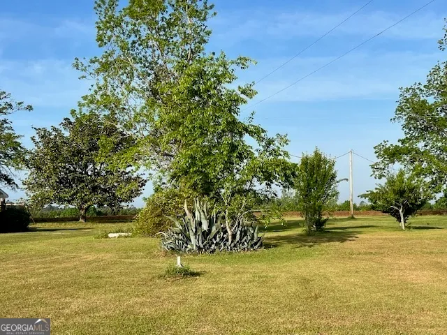 a view of an ocean with house in the background