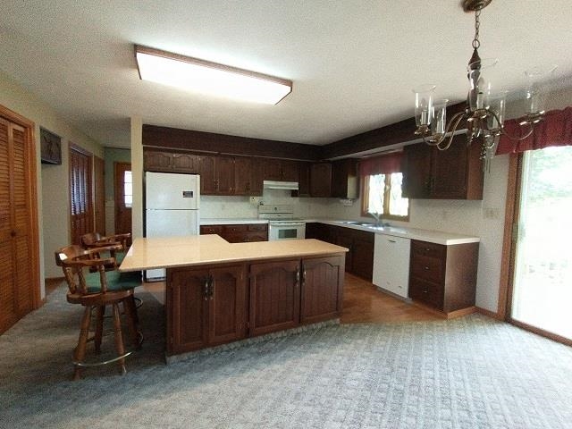 9101 North Church Road Davis, IL 61019 - Photo 5 of 38 a kitchen with kitchen island a sink stainless steel appliances and cabinets