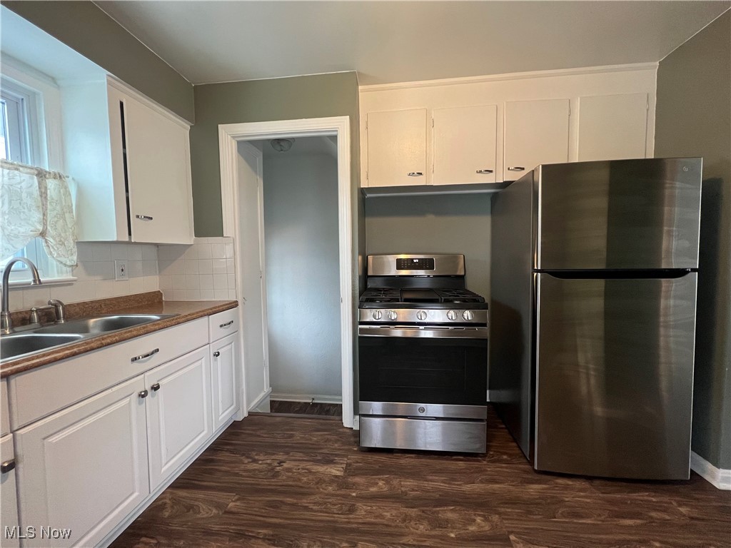 20611 Franklin Road Maple Heights, OH 44137 - Photo 11 of 31 Kitchen featuring white cabinetry, sink, dark wood-type flooring, and stainless steel appliances