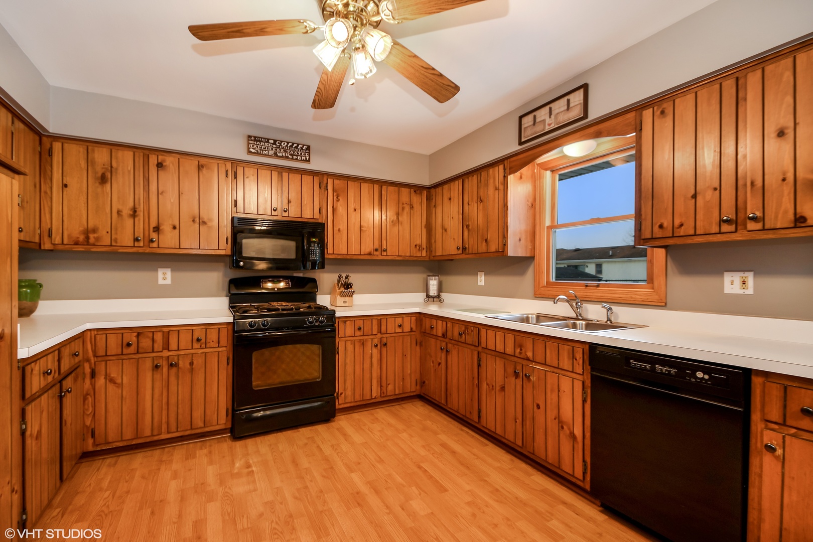921 Barnside Road New Lenox, IL 60451 - Photo 6 of 27 a kitchen with stainless steel appliances granite countertop wooden cabinets a sink a stove a refrigerator and island with wooden floors