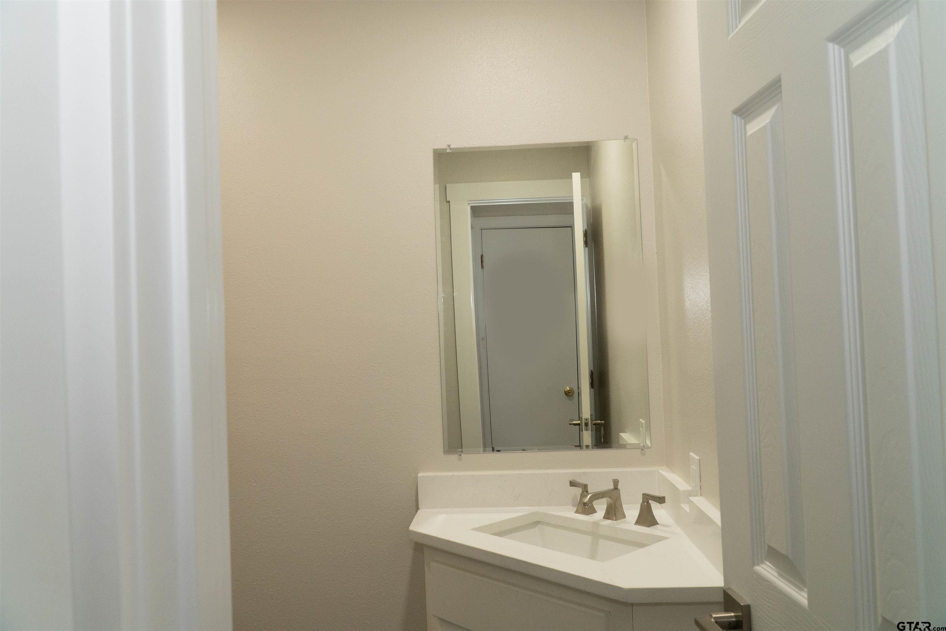224 Miller Road Scroggins, TX 75480 - Photo 12 of 24 a bathroom with a sink and a mirror