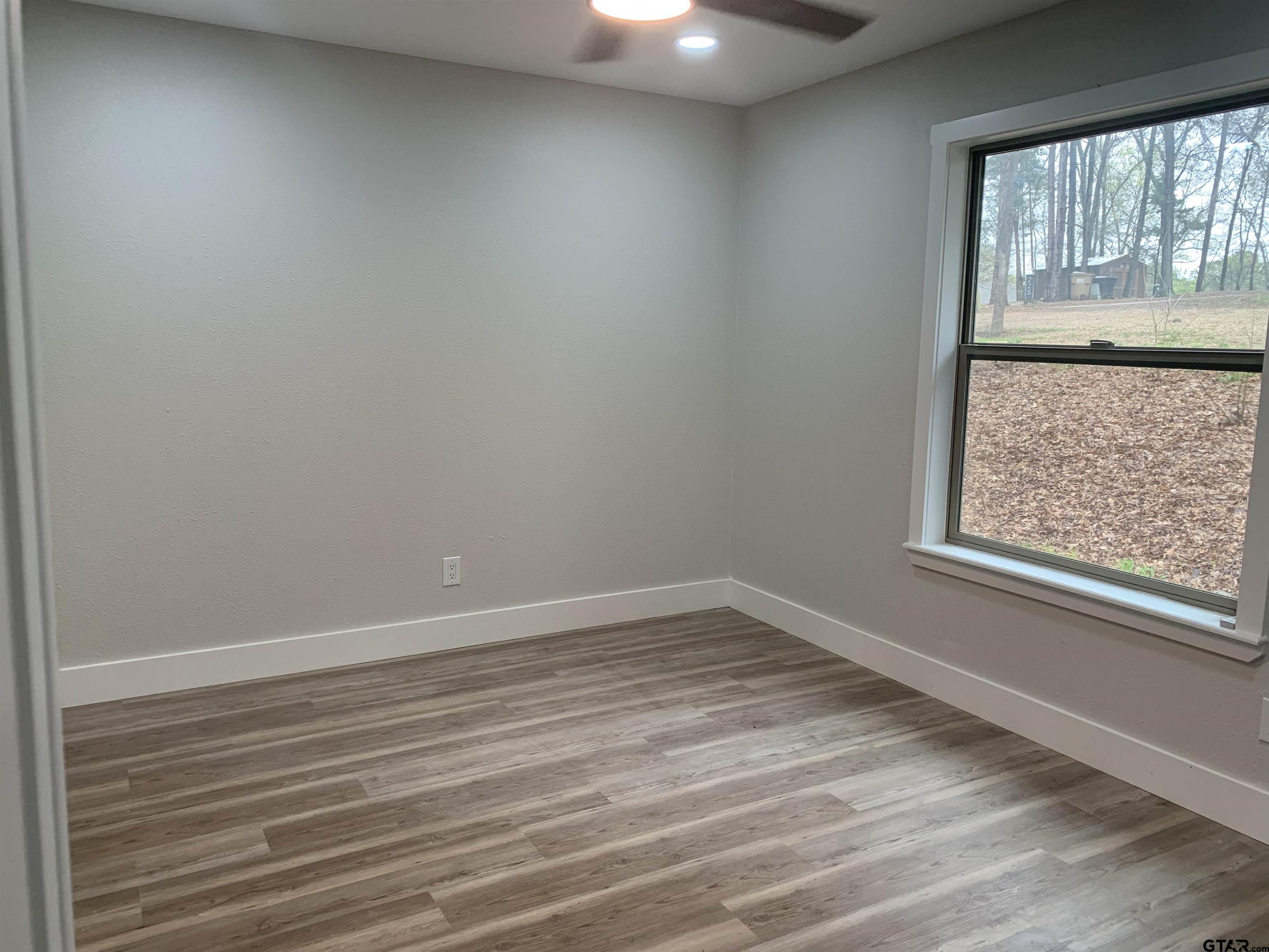224 Miller Road Scroggins, TX 75480 - Photo 13 of 24 wooden floor in an empty room with a window