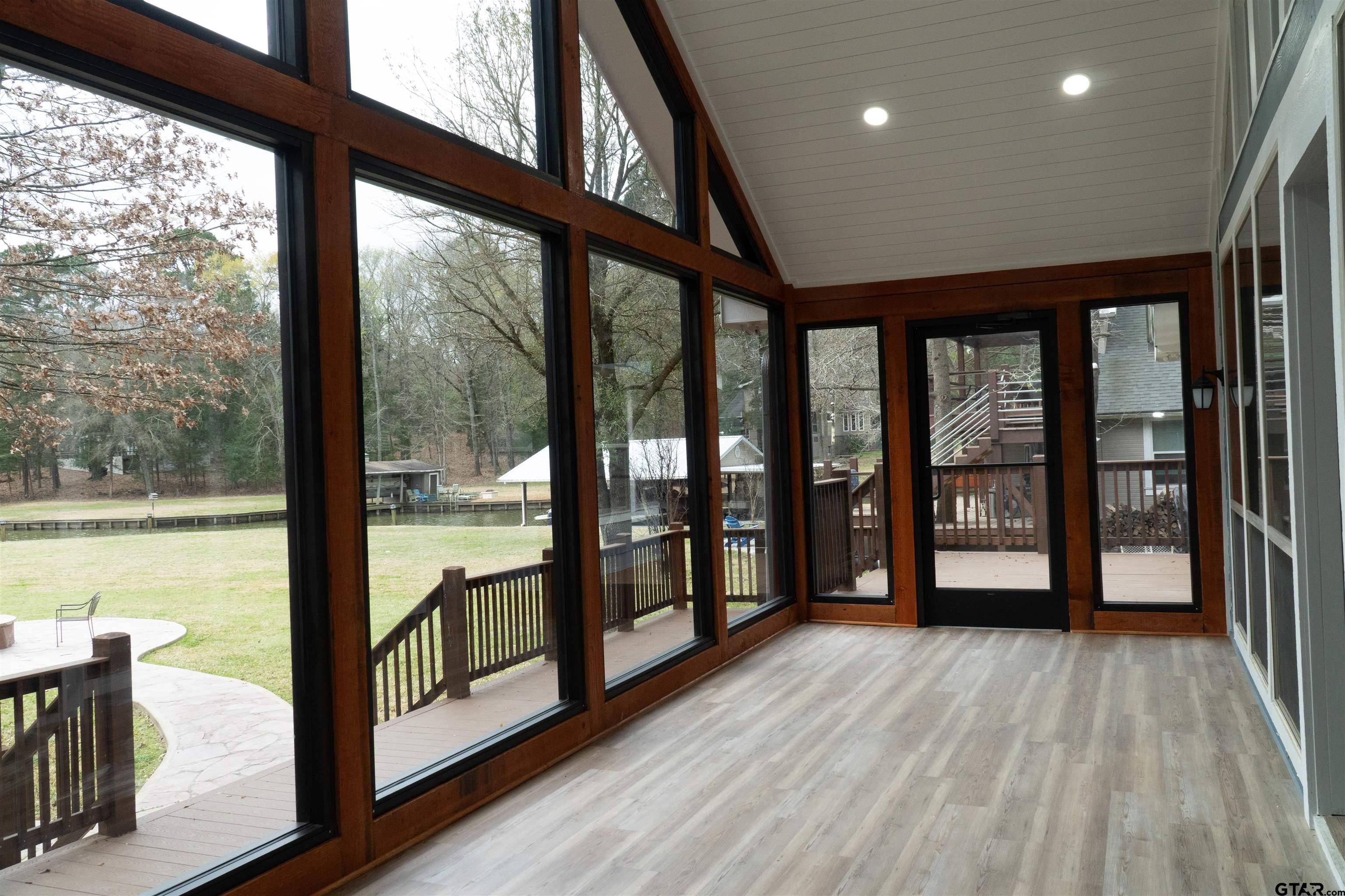 224 Miller Road Scroggins, TX 75480 - Photo 18 of 24 a view of an empty room with wooden floor and a balcony