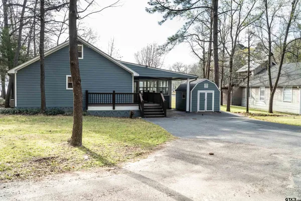 a view of a house with a yard and sitting area