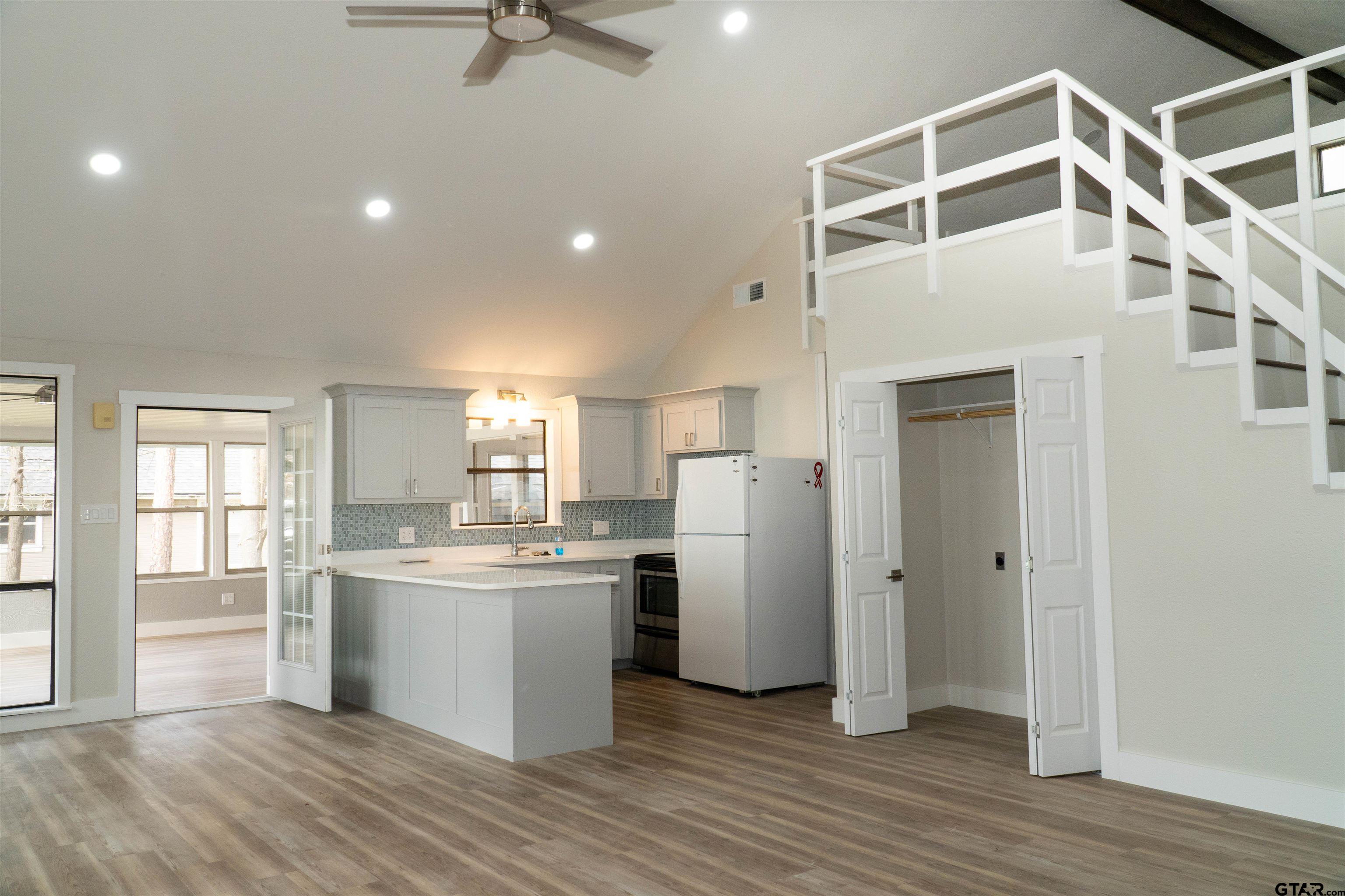 224 Miller Road Scroggins, TX 75480 - Photo 7 of 24 a kitchen with refrigerator cabinets and wooden floor