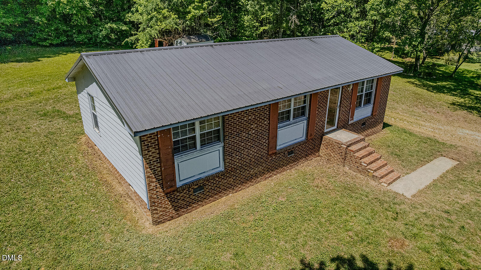 1302 Blacksmith Road Efland, NC 27243 - Photo 46 of 46 a roof deck with table and chairs under an umbrella