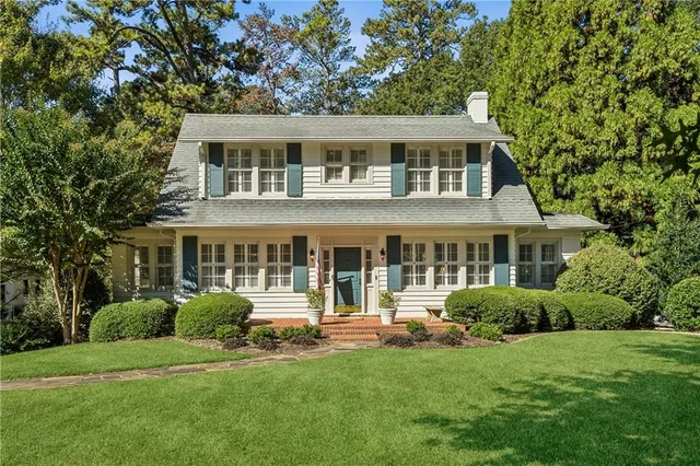 a front view of a house with a garden