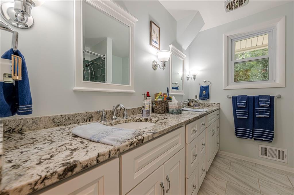 3671 Cold Spring Lane Atlanta, GA 30341 - Photo 13 of 26 a bathroom with a granite countertop sink and a mirror