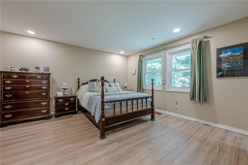 3671 Cold Spring Lane Atlanta, GA 30341 - Photo 16 of 26 a bedroom with a bed and a flat tv screen on dresser