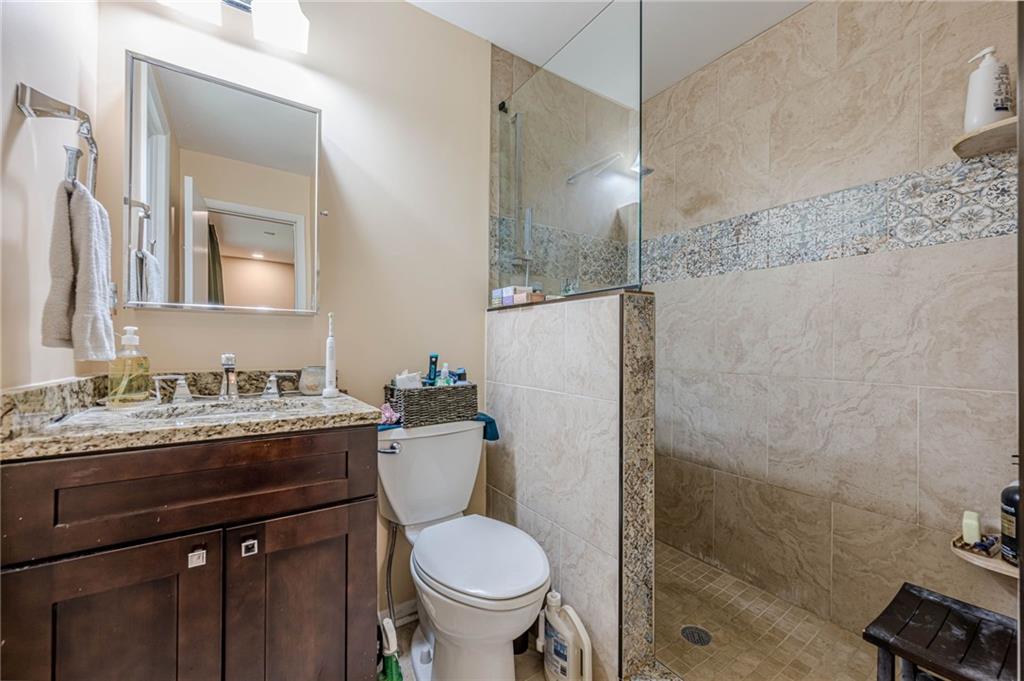 3671 Cold Spring Lane Atlanta, GA 30341 - Photo 18 of 26 a bathroom with a granite countertop sink toilet and shower