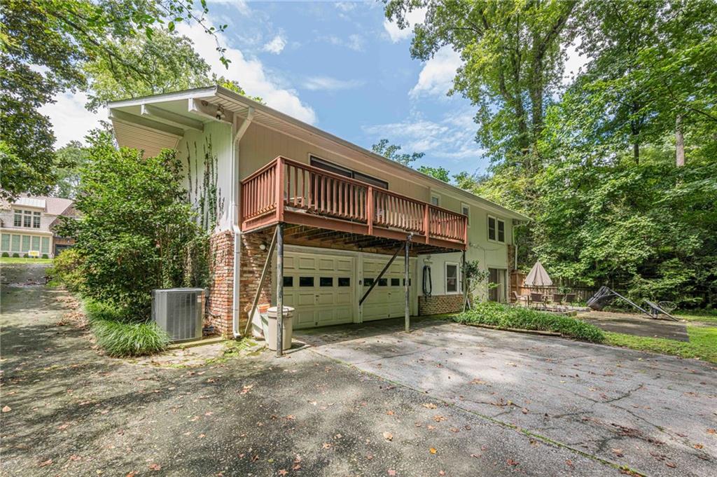 3671 Cold Spring Lane Atlanta, GA 30341 - Photo 22 of 26 a front view of a house with a yard and garage