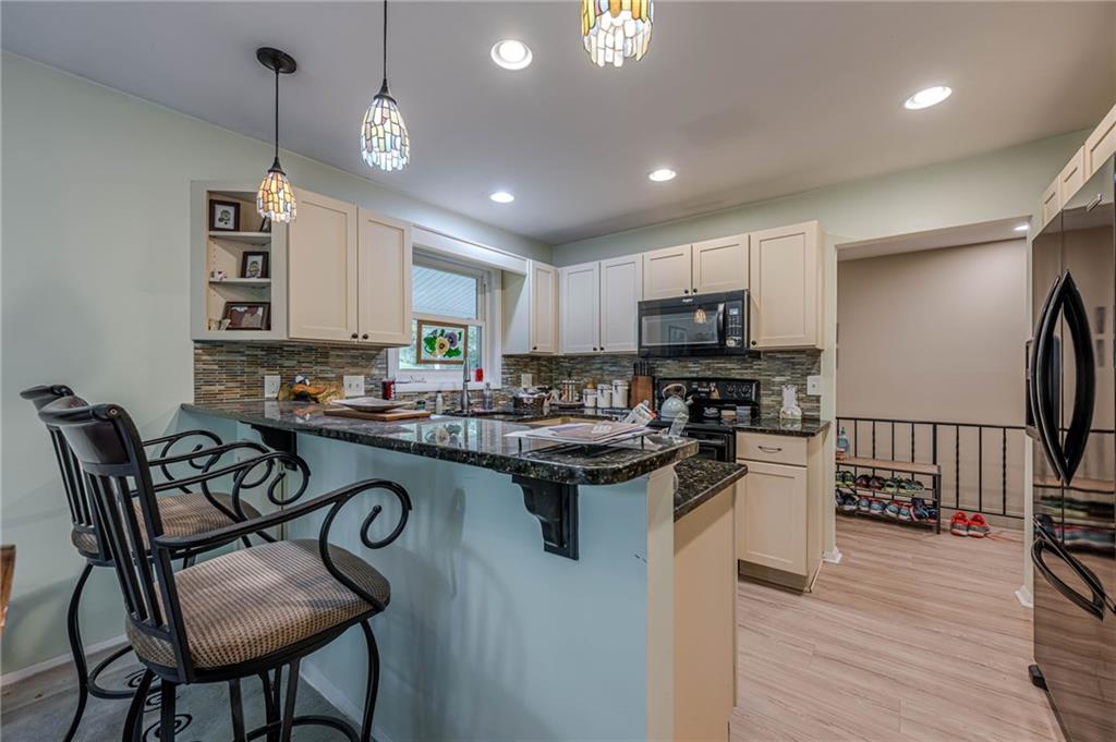 3671 Cold Spring Lane Atlanta, GA 30341 - Photo 5 of 26 a kitchen with sink a counter space appliances and cabinets