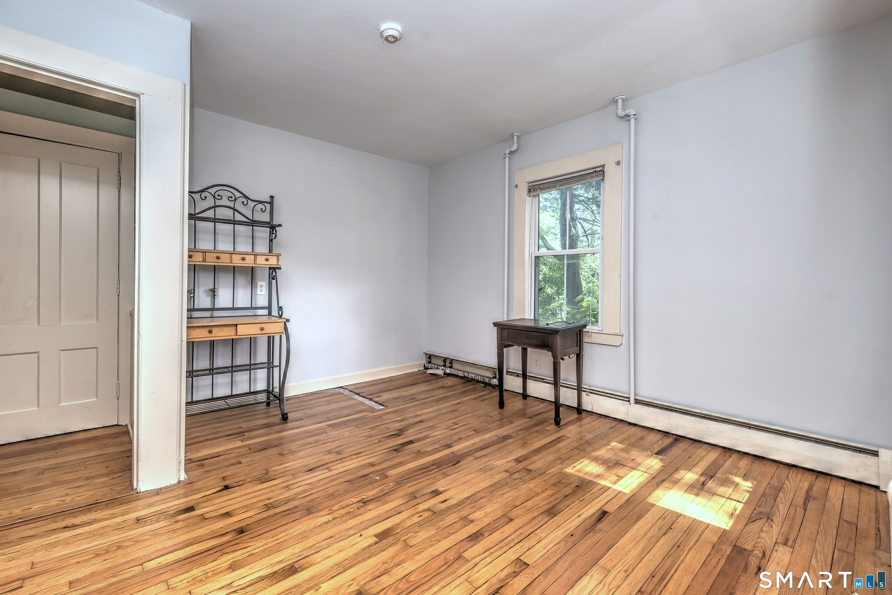 186 Jones Hill Road West Haven, CT 06516 - Photo 14 of 33 a view of an empty room with window and wooden floor