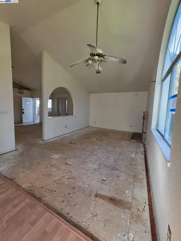 a view of empty room with ceiling fan