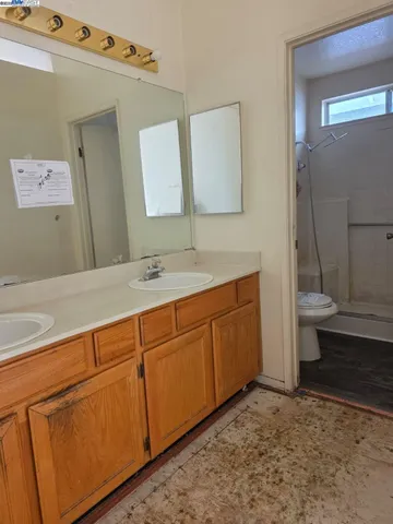 a bathroom with a sink a toilet and mirror