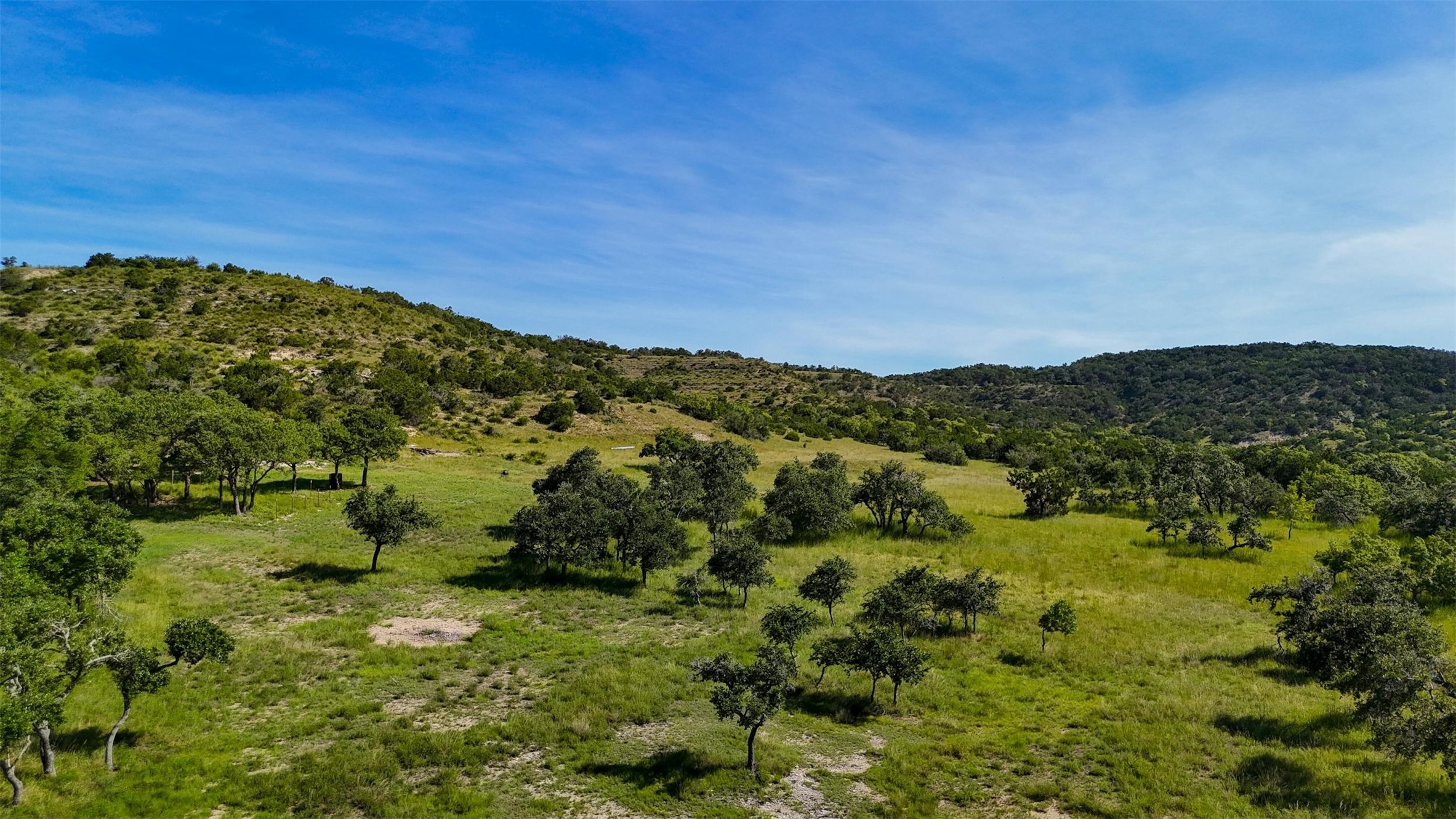 1215 Montell Road Wimberley, TX 78676 - Photo 2 of 38 a view of a field with an ocean