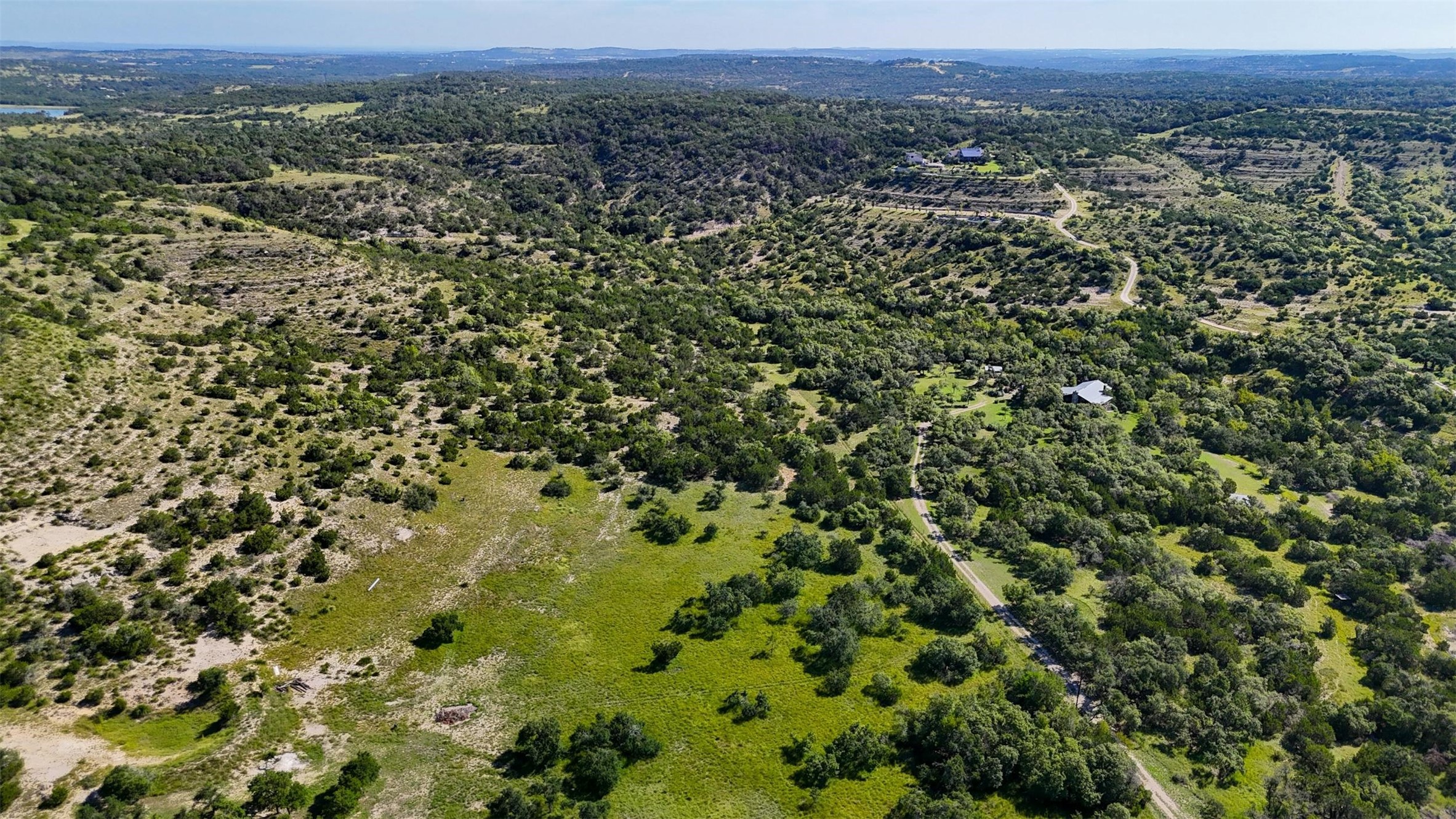 1215 Montell Road Wimberley, TX 78676 - Photo 26 of 38 an aerial view of a houses with a yard and mountain view