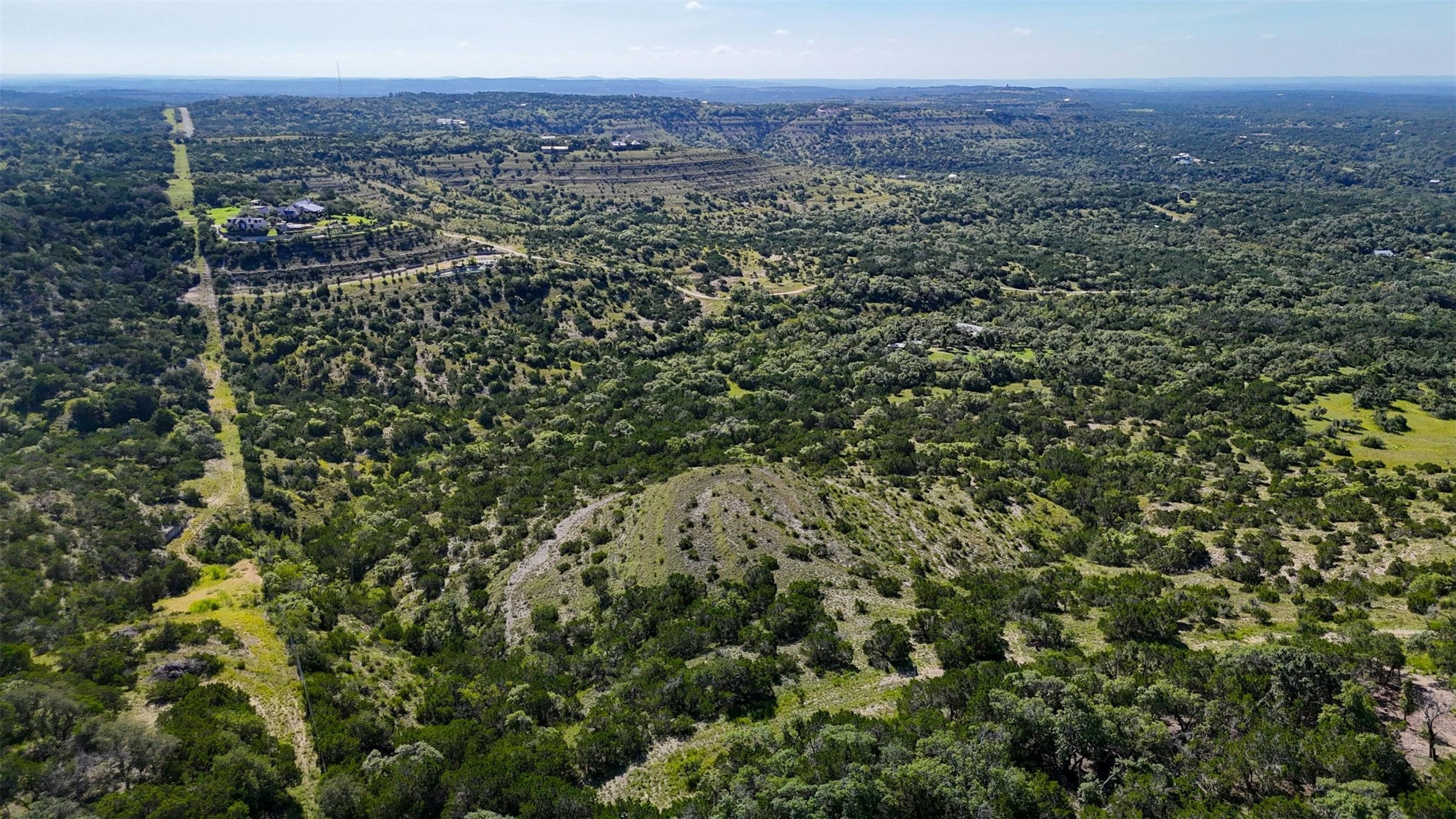 1215 Montell Road Wimberley, TX 78676 - Photo 29 of 38 a view of a city with lush green forest