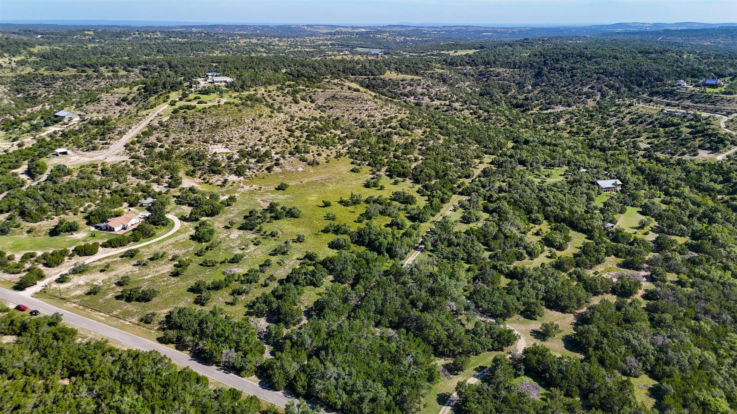 1215 Montell Road Wimberley, TX 78676 - Photo 34 of 38 an aerial view of residential houses with outdoor space and trees