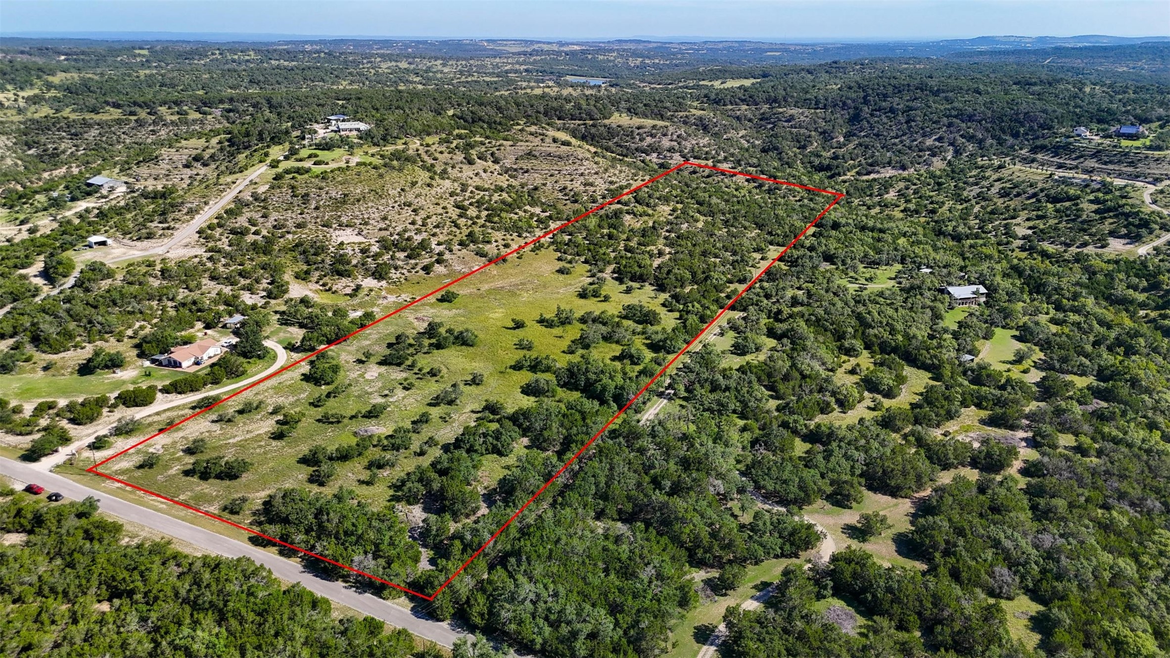 1215 Montell Road Wimberley, TX 78676 - Photo 36 of 38 an aerial view of residential houses with outdoor space and trees