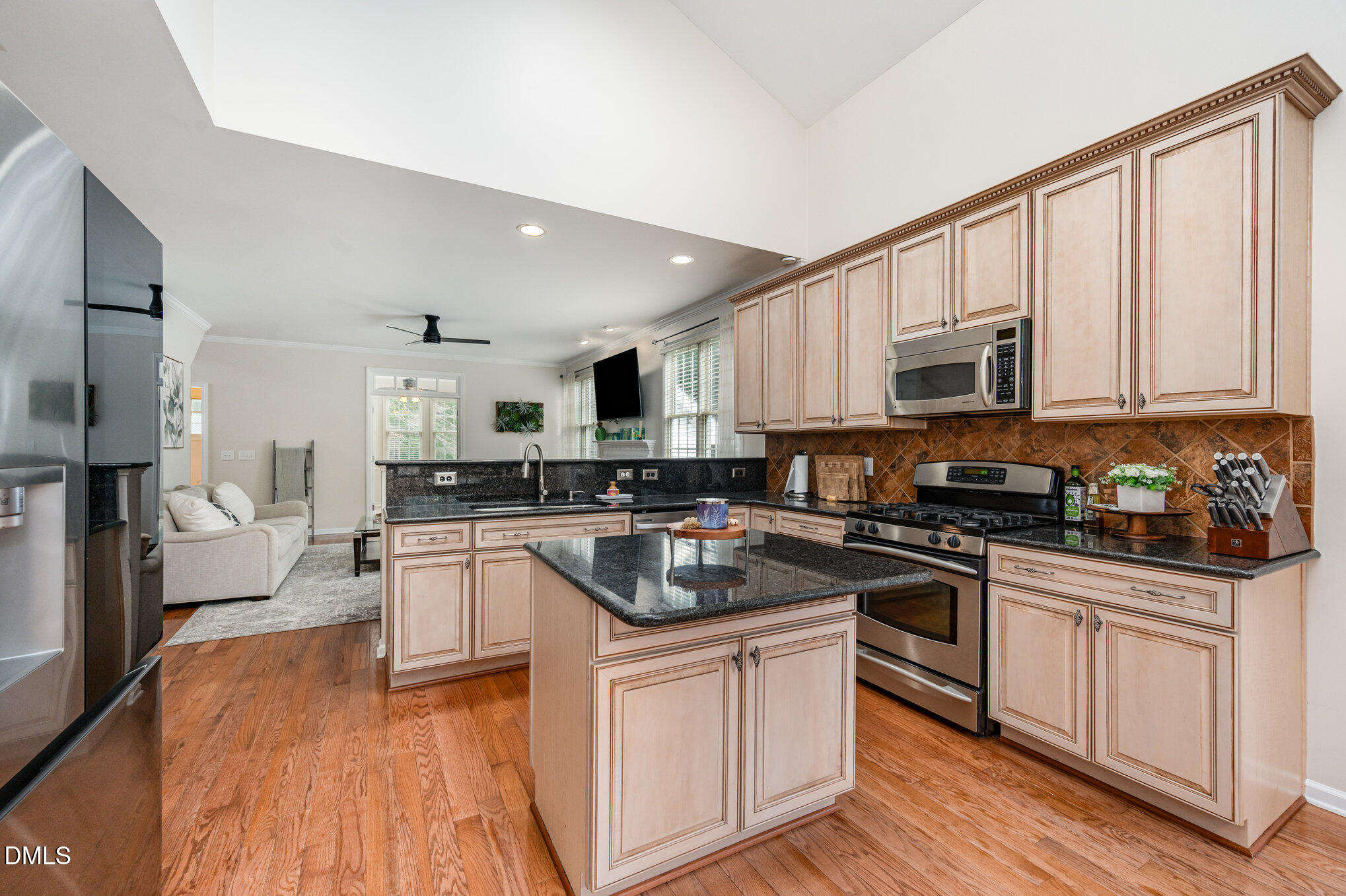 2116 Covered Bridge Court Raleigh, NC 27614 - Photo 14 of 36 a kitchen with white cabinets appliances and wooden floor