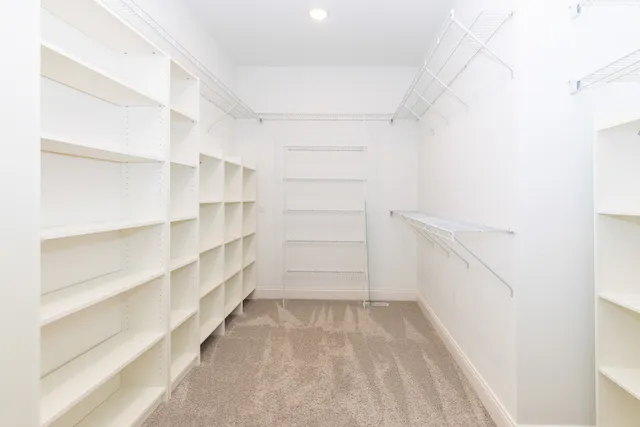 a view of walk in closet with empty racks