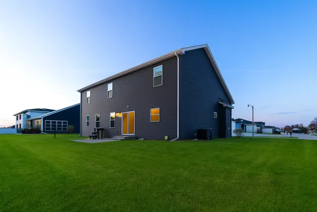 a brick house with a big yard and front of a house