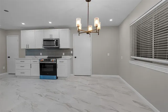 a view of kitchen with microwave and stove