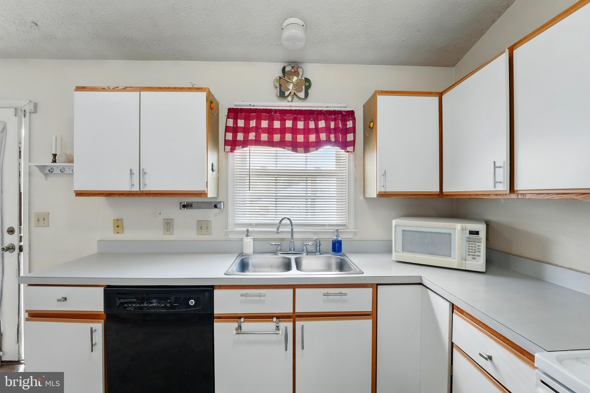 6775 Rugby Place Bealeton, VA 22712 - Photo 13 of 43 a kitchen with stainless steel appliances a sink cabinets and a window