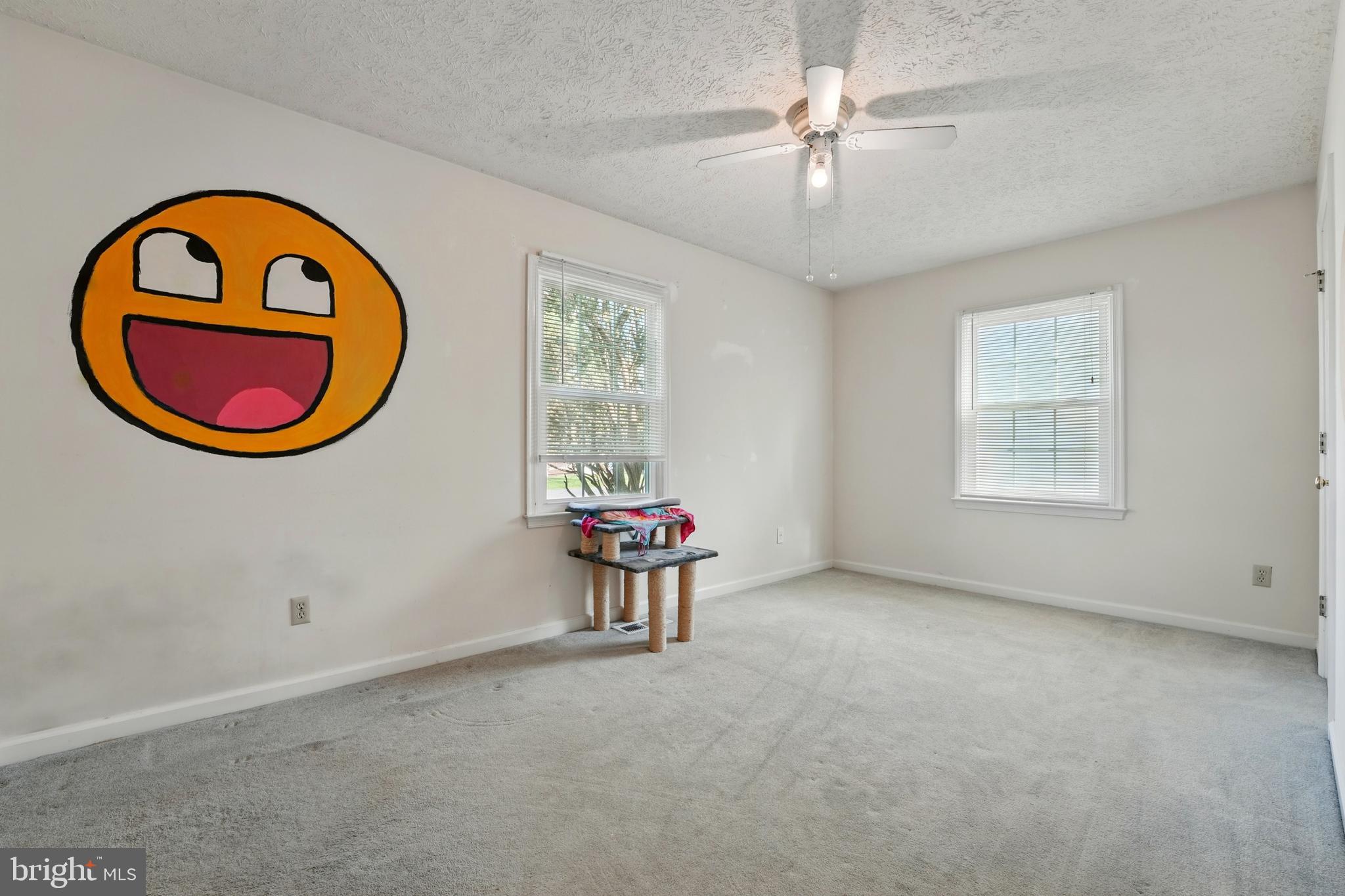6775 Rugby Place Bealeton, VA 22712 - Photo 20 of 43 an empty room with a chandelier fan and windows