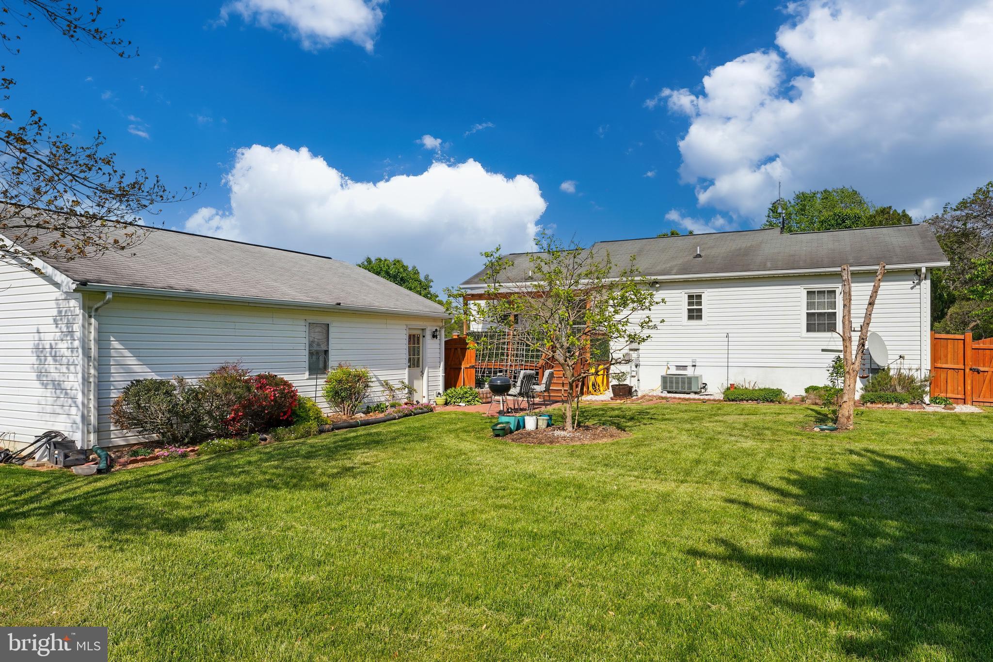 6775 Rugby Place Bealeton, VA 22712 - Photo 32 of 43 a view of a house with a yard and sitting area