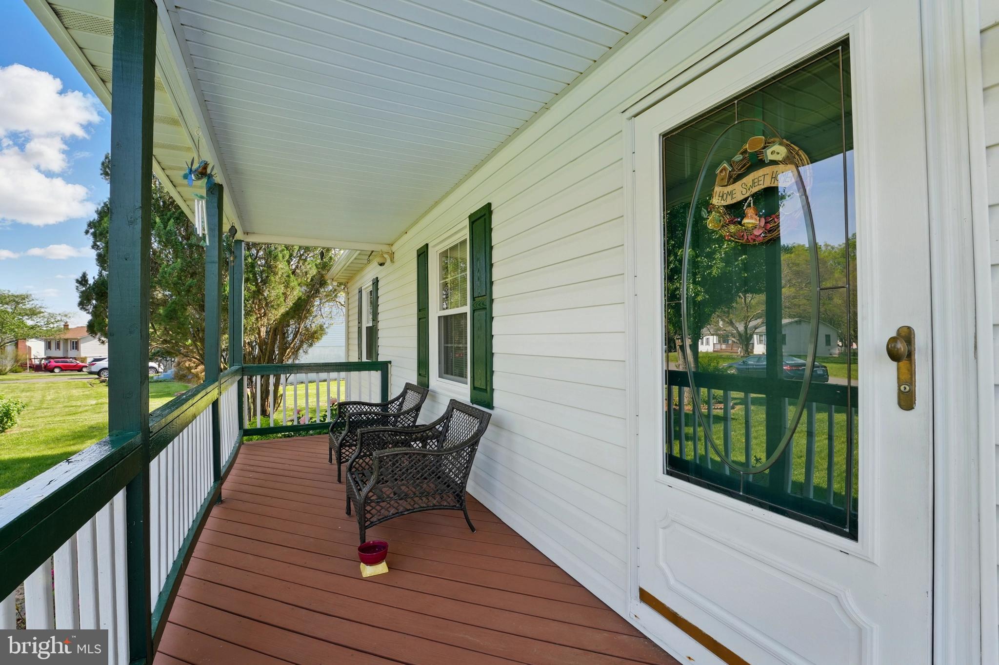 6775 Rugby Place Bealeton, VA 22712 - Photo 7 of 43 a view of a balcony with chairs and wooden floor