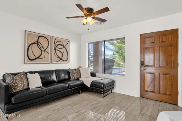 a living room with furniture and a large window