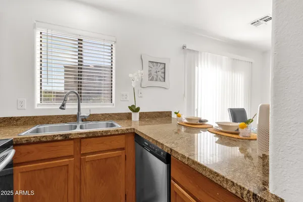 a kitchen with granite countertop a sink and a window