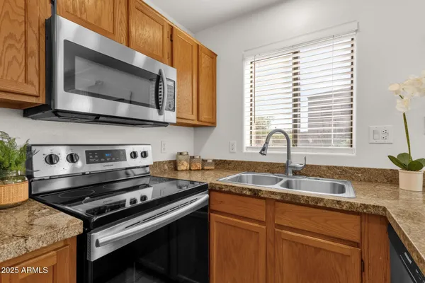 a kitchen with a stove microwave and sink