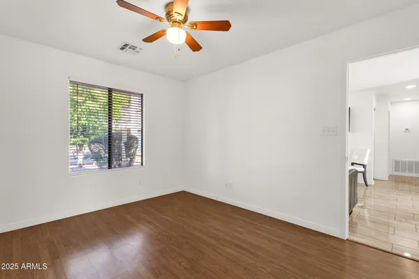 wooden floor in an empty room with a window