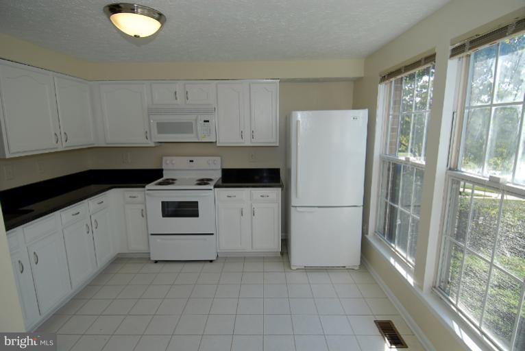 1489 Autumn Ridge Circle Reston, VA 20194 - Photo 1 of 23 a white refrigerator freezer sitting inside of a kitchen