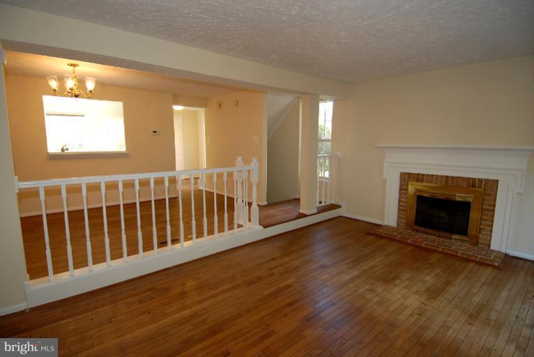 1489 Autumn Ridge Circle Reston, VA 20194 - Photo 14 of 23 a view of an empty room with wooden floor and a window