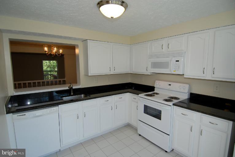 1489 Autumn Ridge Circle Reston, VA 20194 - Photo 15 of 23 a kitchen with granite countertop white cabinets and sink